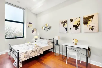 a bedroom with a bed and a table and a desk at XL Studio - Premier Studio with Gym Access in Philadelphia