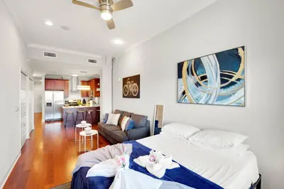 a bedroom with a bed and a living room at XL Studio - Stylish Studio with Rooftop Pool in Philadelphia