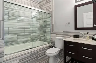 a bathroom with a tub and a toilet and a sink at XL Studio - Stylish Studio with Rooftop Pool in Philadelphia
