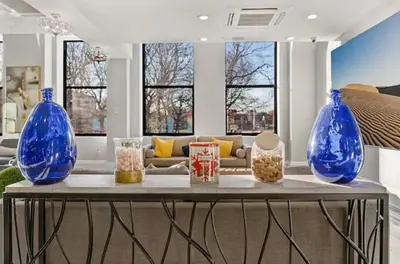 two blue vases sitting on a table in a living room at XL Studio - Stylish Studio with Rooftop Pool in Philadelphia