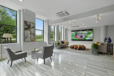 a living room with a dog laying on the floor at XL Studio - Modern Studio with Rooftop Pool in Philadelphia