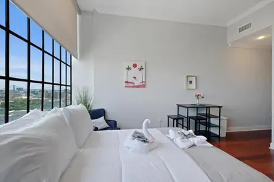 a bedroom with a large white bed with towels on it at XL Studio - Luxury Studio Near Center City in Philadelphia