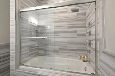 a bathroom with a tub with a glass shower at XL Studio - Luxury Studio Near Center City in Philadelphia
