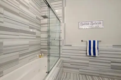 a bathroom with a glass shower and a tub at XL Studio - Luxury Studio Near Center City in Philadelphia