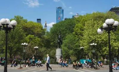 a group of people sitting on benches in a park at Chic One Bedroom Retreat in Downtown Manhattan in New York