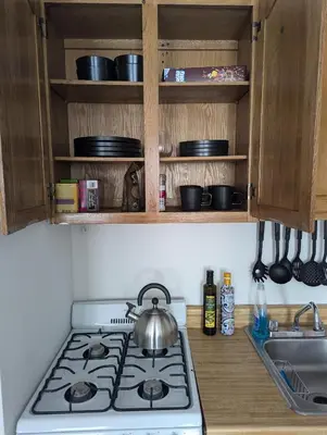a kitchen stove with a tea kettle on top of it at Chic One Bedroom Retreat in Downtown Manhattan in New York