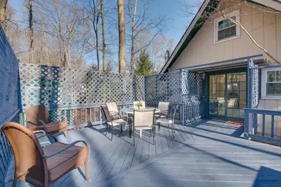 a patio with chairs and a table on a deck at Arrowhead Lake Access Cabin with Resort Amenities in Pocono Lake