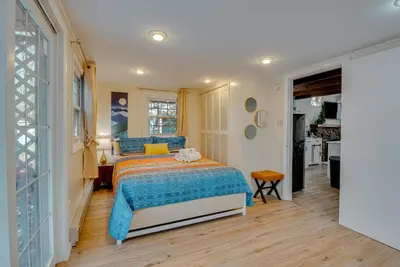 a bedroom with a bed with a blue blanket at Arrowhead Lake Access Cabin with Resort Amenities in Pocono Lake