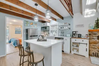 a kitchen with white appliances and wooden ceilings at Arrowhead Lake Access Cabin with Resort Amenities in Pocono Lake
