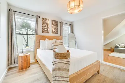 a white bedroom with a bed and a window at Beach and Lake Access Family Poconos Home with Deck in Tobyhanna