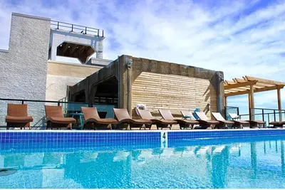 a swimming pool with chairs next to a building at XL Studio - Chic Flat - Rooftop Pool & Gym in Philadelphia