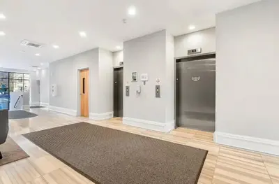 an empty room with a door and a rug at XL Studio - Chic Flat - Rooftop Pool & Gym in Philadelphia