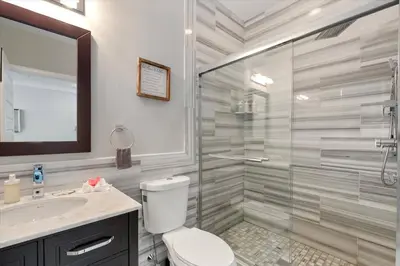 a bathroom with a shower and a toilet and a sink at XL Studio - Chic Flat - Rooftop Pool & Gym in Philadelphia