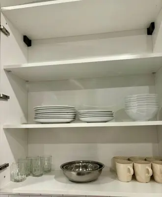 a shelf with plates and bowls in a kitchen at Veau3 1BD 1BA minutes to NYC in Newark