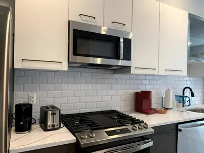 a kitchen with a stove top and a microwave at Veau3 1BD 1BA minutes to NYC in Newark