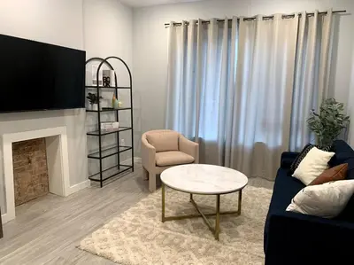 a living room with a couch and a chair and a table at Veau3 1BD 1BA minutes to NYC in Newark