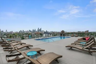 a group of chairs and a swimming pool on a building at XL Studio - Magnificent Studio with Rooftop Pool in Philadelphia