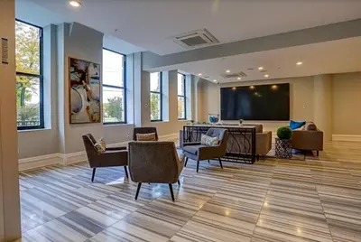 a waiting room with chairs and a projection screen at XL Studio - Magnificent Studio with Rooftop Pool in Philadelphia