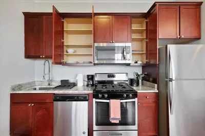 a kitchen with a stove and a refrigerator at XL Studio - Magnificent Studio with Rooftop Pool in Philadelphia