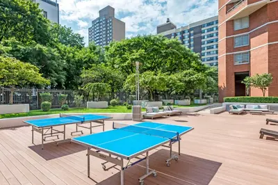two ping pong tables in a courtyard with buildings at Kips Bay 1br w doorman wd gym nr hospital NYC-1402 in New York