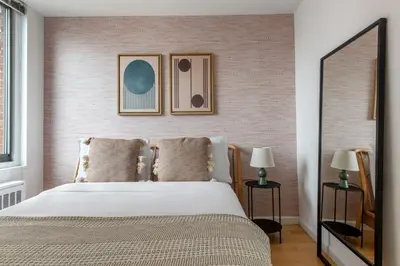 a bedroom with a bed and two pictures on the wall at Kips Bay 1br w doorman wd gym nr hospital NYC-1402 in New York
