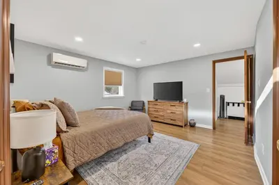 a bedroom with a bed and a flat screen tv at The Edamame House in Nazareth