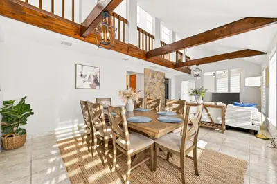 a dining room with a wooden table and chairs at The Edamame House in Nazareth