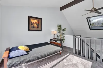 a bedroom with a bed and a ceiling fan at Heart of Pocono Mtn 3bd 2ba Gameroom Pocono Raceway in Long Pond