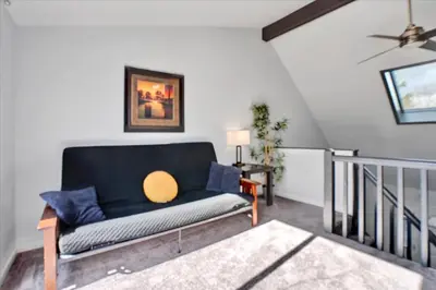 a living room with a blue couch and a table at Heart of Pocono Mtn 3bd 2ba Gameroom Pocono Raceway in Long Pond