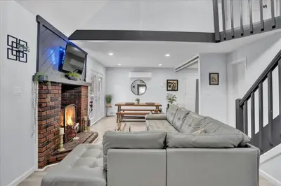 a living room with a couch and a fireplace at Heart of Pocono Mtn 3bd 2ba Gameroom Pocono Raceway in Long Pond