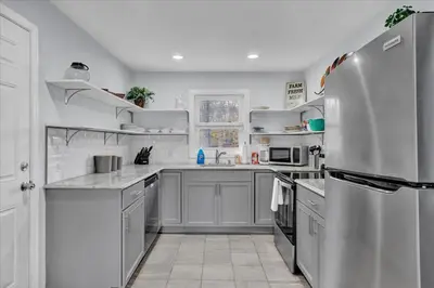 a kitchen with white appliances and a refrigerator at Heart of Pocono Mtn 3bd 2ba Gameroom Pocono Raceway in Long Pond