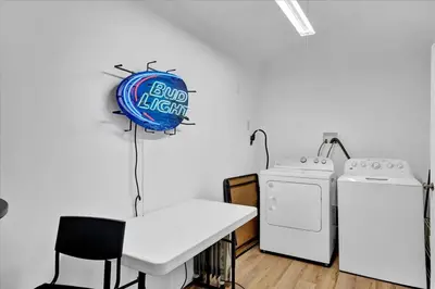 a kitchen with a stove and a sign on the wall at Heart of Pocono Mtn 3bd 2ba Gameroom Pocono Raceway in Long Pond