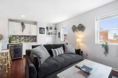 a living room with a couch and a table at Double Decker Roofdeck Gorgeous View in Passyunk in Philadelphia