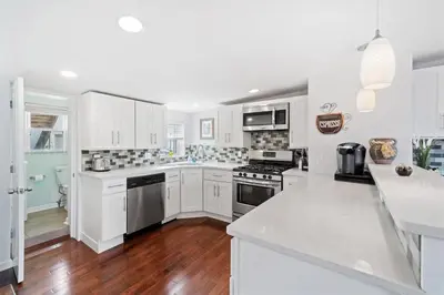a kitchen with white cabinets and a white counter top at Double Decker Roofdeck Gorgeous View in Passyunk in Philadelphia