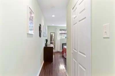 a hallway with a white door and a bedroom at Double Decker Roofdeck Gorgeous View in Passyunk in Philadelphia