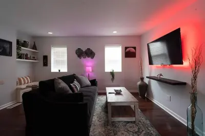 a living room with a couch and a table at Double Decker Roofdeck Gorgeous View in Passyunk in Philadelphia