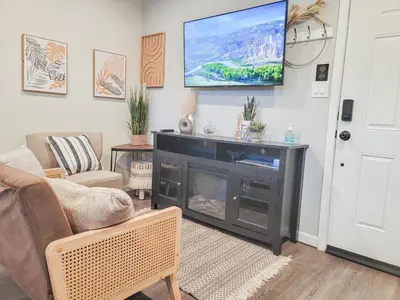 a living room with a television above a fireplace at Unique Studio in York in York