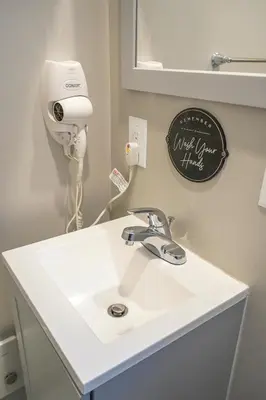 a bathroom with a white sink and a hair dryer at Unique Studio in York in York