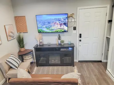 a living room with a flat screen tv on the wall at Unique Studio in York in York