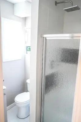 a bathroom with a toilet and a glass shower at Unique Studio in York in York