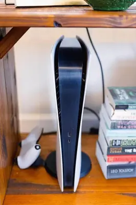 a black and white router sitting on a shelf with books at Rainforest Retreat 20m to NYC FREE Parking - Sleeps 16 in Bayonne