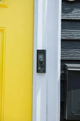 a yellow door with a knob on the side of a house at Rainforest Retreat 20m to NYC FREE Parking - Sleeps 16 in Bayonne