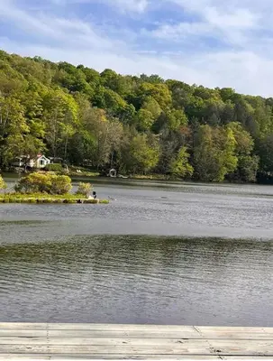 a large body of water with trees in the background at Peaceful place at the lake in Susquehanna