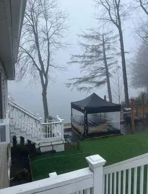 a gazebo with a tent on a yard at Peaceful place at the lake in Susquehanna