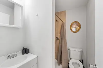 a bathroom with a toilet and a sink and a mirror at Whimsical three in Bayonne