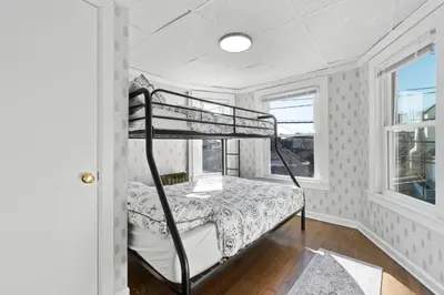 a bedroom with a bunk bed and a window at Whimsical three in Bayonne
