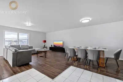 a living room with a couch and a table at UrbanNest XL in Bayonne