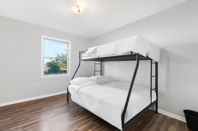 a bedroom with two bunk beds and a window at UrbanNest XL in Bayonne