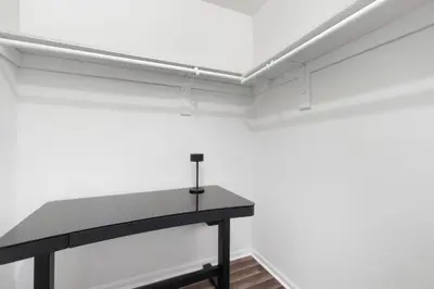 a black table in a white room with a ceiling at UrbanNest XL in Bayonne