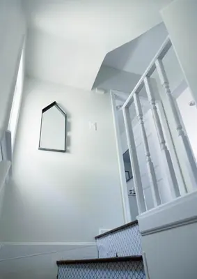 a stair case with a mirror on the wall at Rainforest Retreat 20m to NYC Parking Sleeps 25 in Bayonne